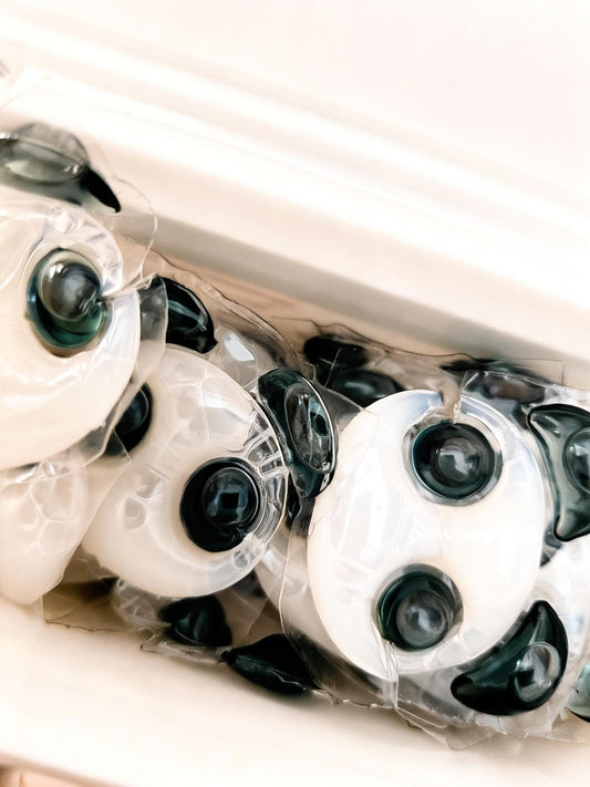 Close-up group of white and black Panda Pod laundry pods