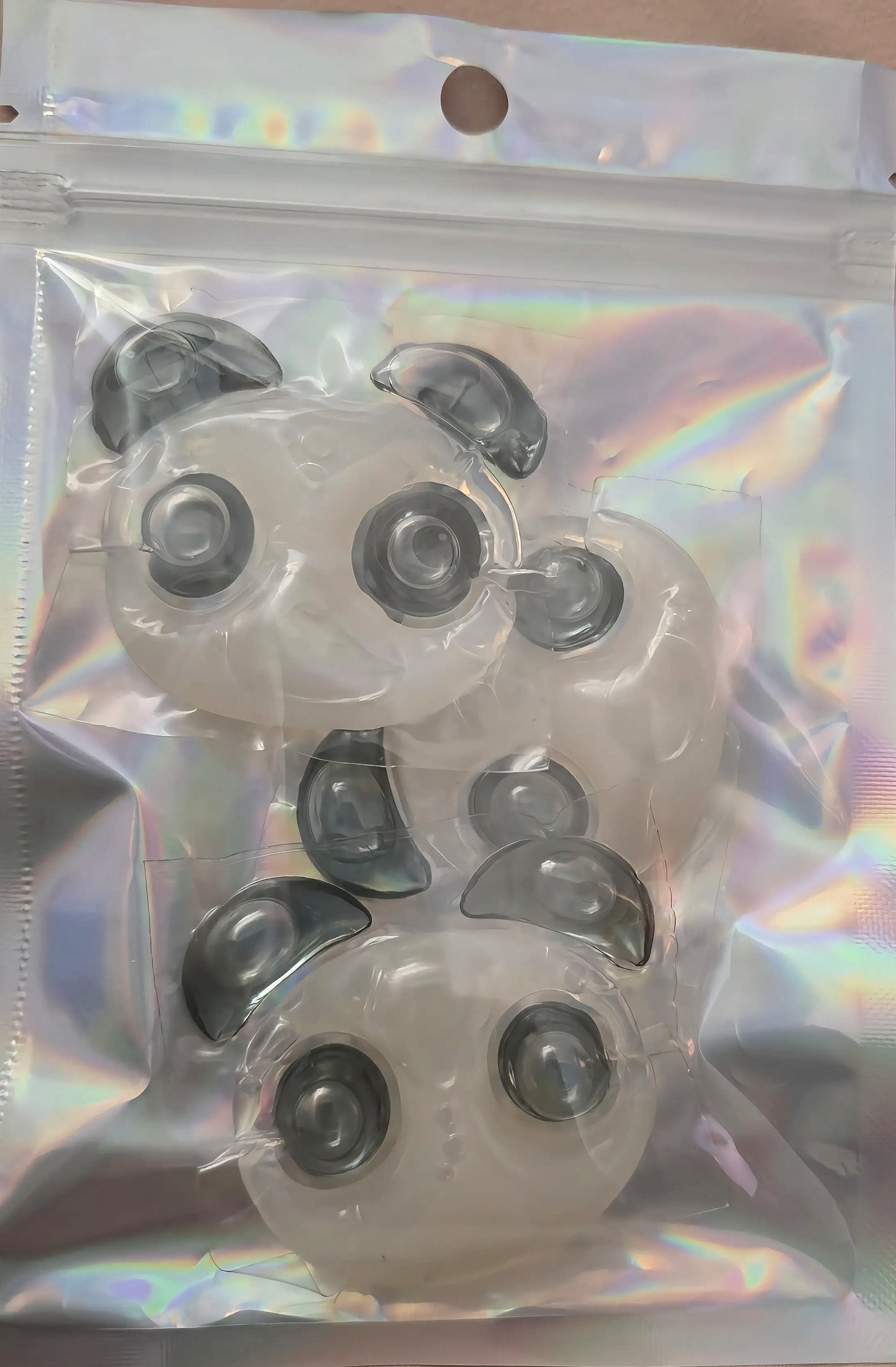 Three Panda Pod laundry pods inside a holographic Cutie Pods sampler pouch