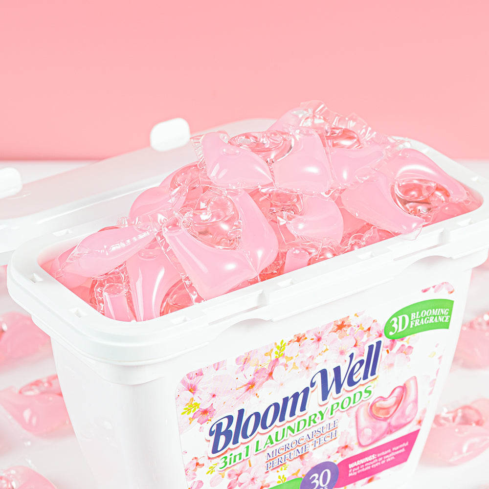 Open tub of Heart Pod laundry pods in Floral Peach, filled with pink heart-shaped pods