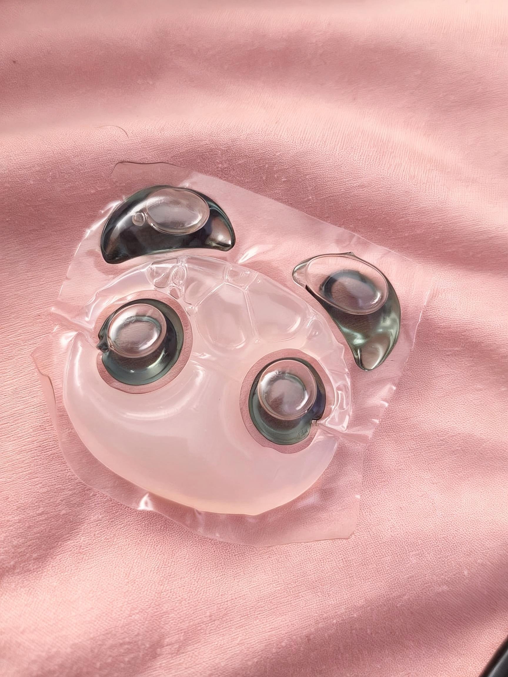 Single Panda Pod laundry pod with black ears and eyes resting on pink fabric