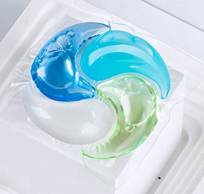 Single four-chamber Swirl Pod laundry pod in blue, teal, green and white, viewed from above