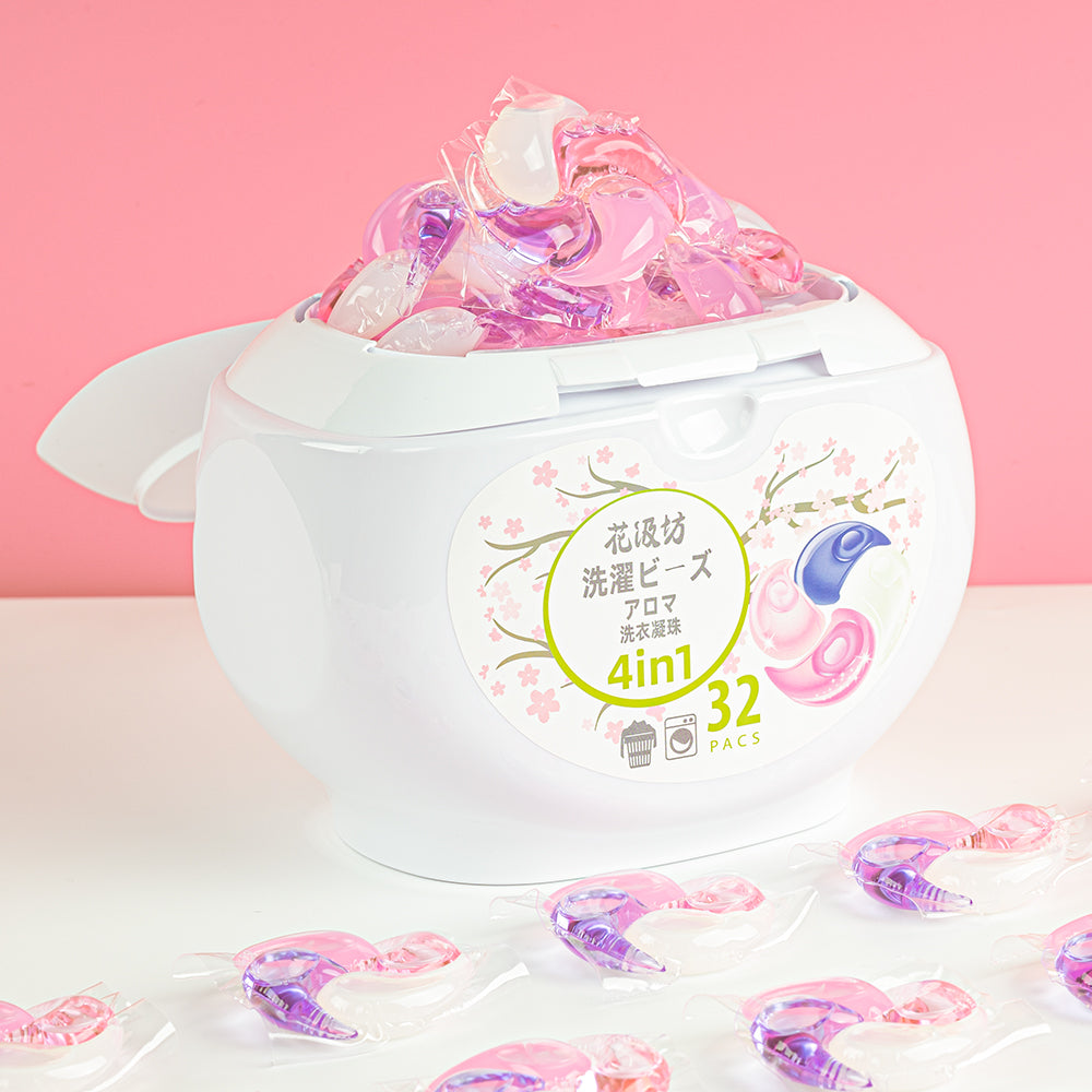 60-count tub of Sakura Blossom Swirl Pod laundry pods on sand with pods beside it