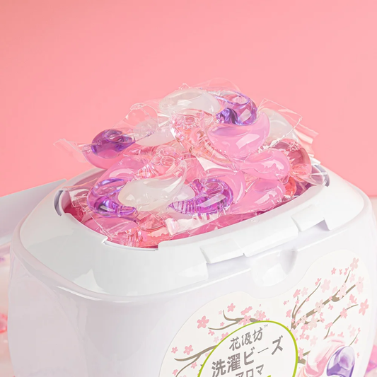 Open tub of Swirl Pod laundry pods in Sakura Blossom filled with pink, purple and white pods